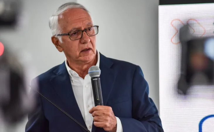 Exministro de salud, Guillermo Jaramillo, con micrófono en mano en una alocución.