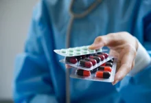 doctor entrega tres blisters de medicamentos - nimesulida